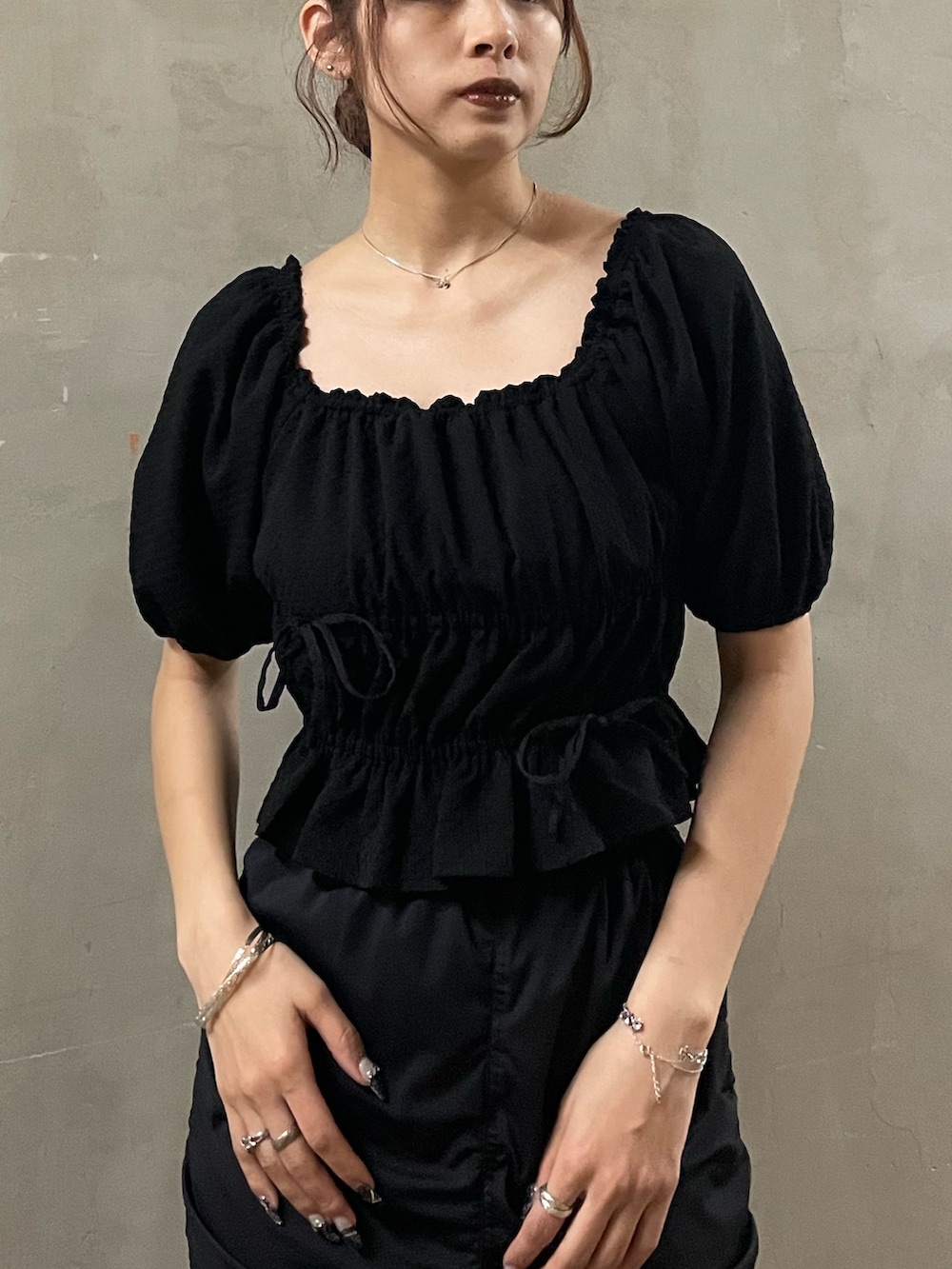 ブラック系のTシャツ/カットソー、ブラック系のスカート、ブラック系のサンダルを着用したレディースの春コーディネートの4枚目の写真