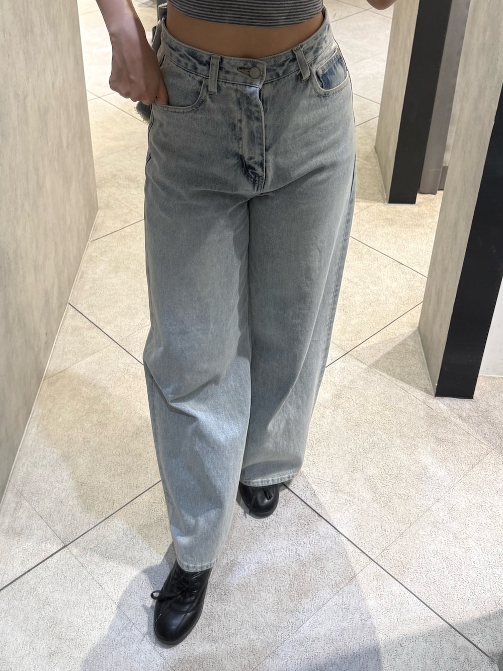 グレー系のTシャツ/カットソー、ブルー系のデニムパンツ、ブラック系のスニーカーを着用したレディースの春コーディネートの5枚目の写真