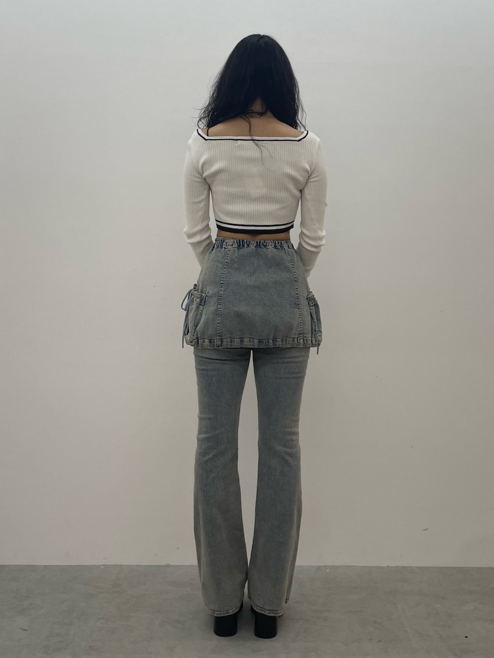 ホワイト系のニット/セーター、ブルー系のデニムパンツ、ブラック系のローファーを着用したレディースの夏コーディネートの3枚目の写真