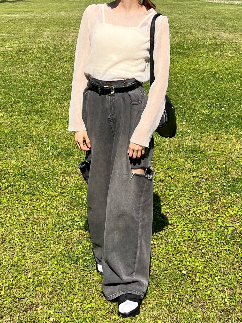 グレー系のデニムパンツ、ホワイト系のシャツ/ブラウス、ブラック系のショルダーバッグを着用したレディースの夏コーディネートの2枚目の写真