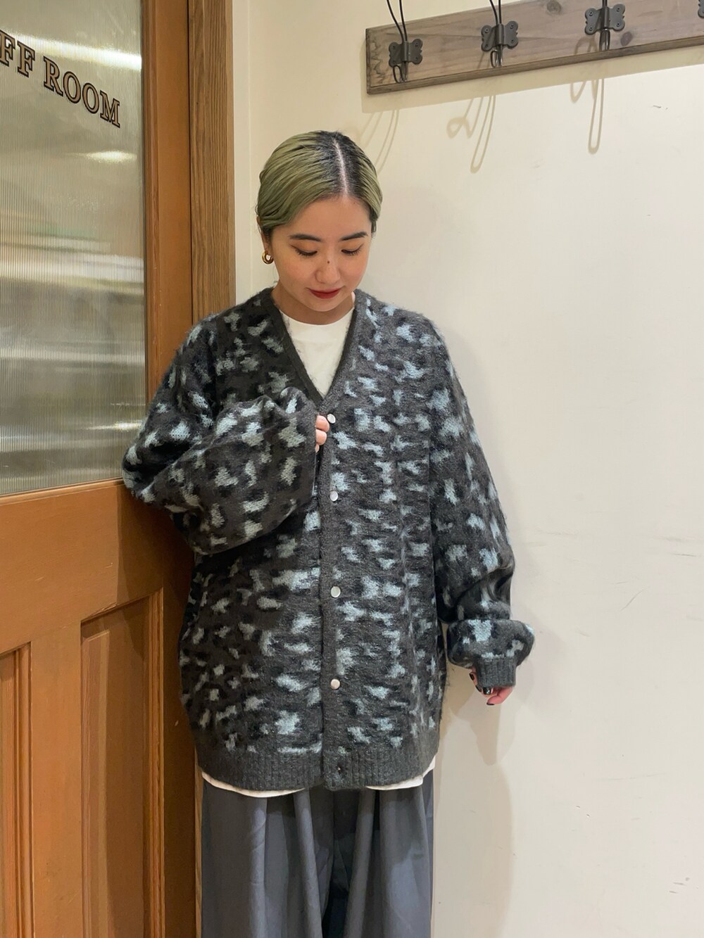 ベージュ系のカーディガン/ボレロ、グレー系のスラックス、ブラック系のハンドバッグを着用したレディースの秋コーディネートの3枚目の写真