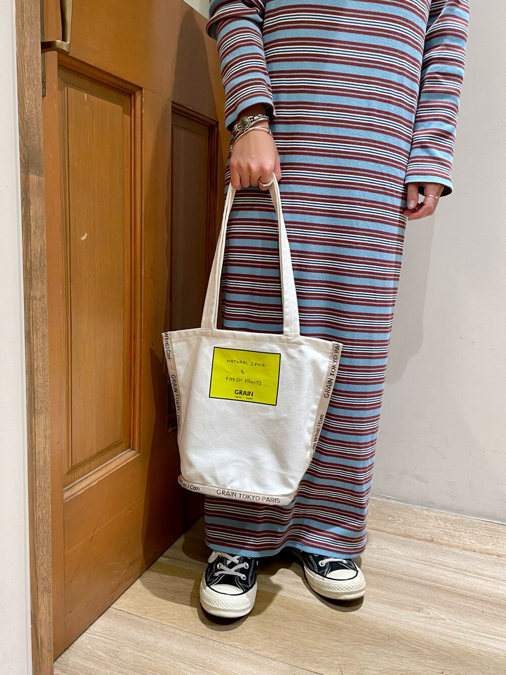 ブルー系のワンピース、ホワイト系のトートバッグを着用したレディースの秋コーディネートの5枚目の写真