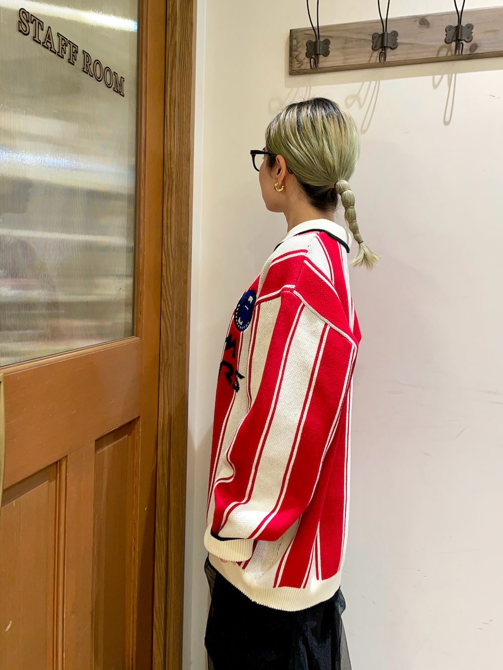 グリーン系のバックパック/リュック、ブラック系のスカート、レッド系のニット/セーターを着用したレディースの秋コーディネートの4枚目の写真