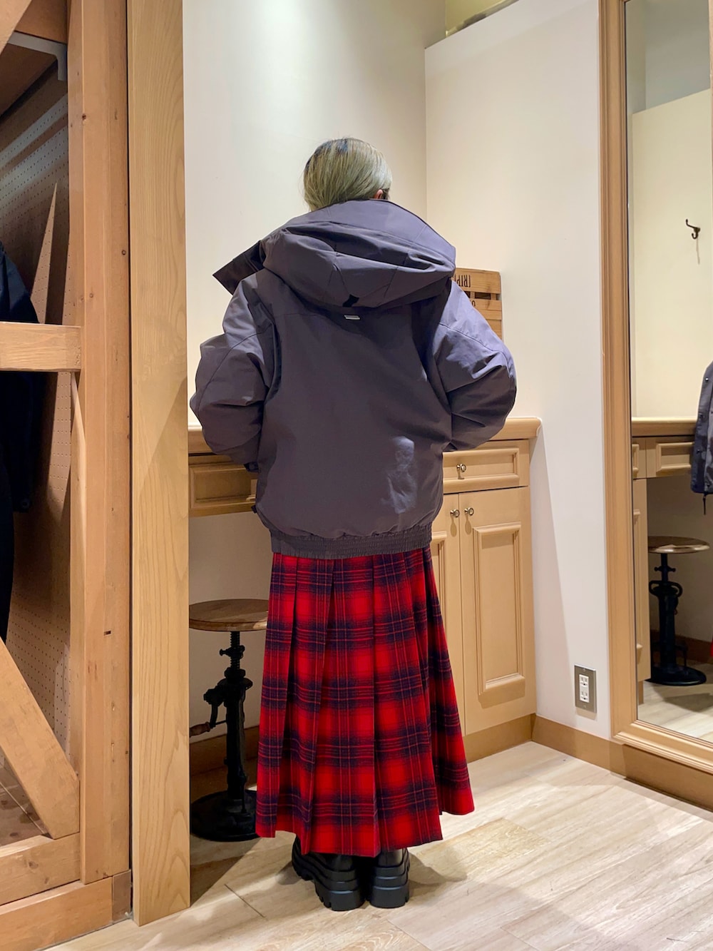 グレー系のダウンジャケット/コート、レッド系のスカート、ブラック系のパンプスを着用したレディースの冬コーディネートの2枚目の写真