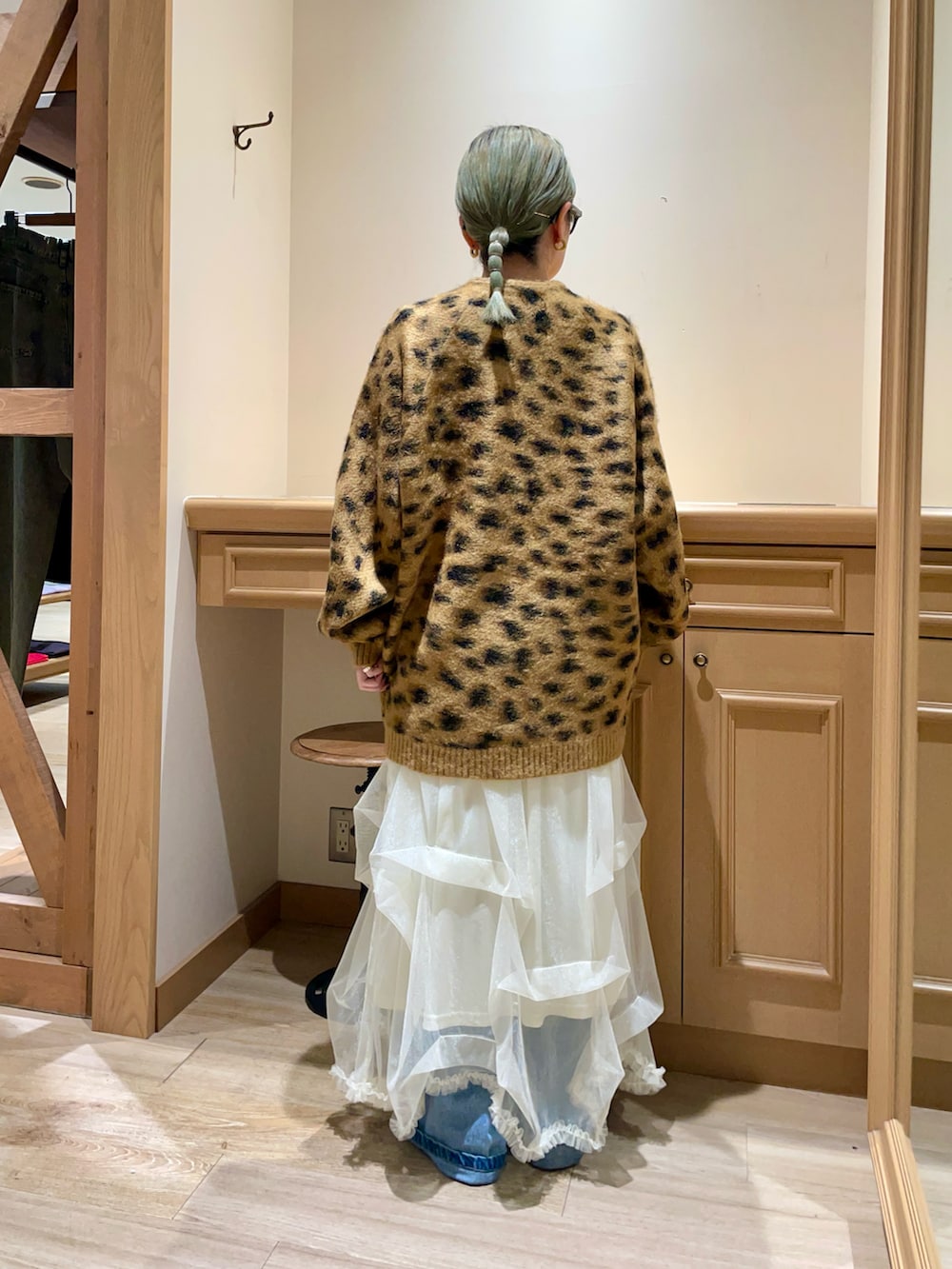 ベージュ系のカーディガン/ボレロ、ホワイト系のスカートを着用したレディースの秋コーディネートの2枚目の写真