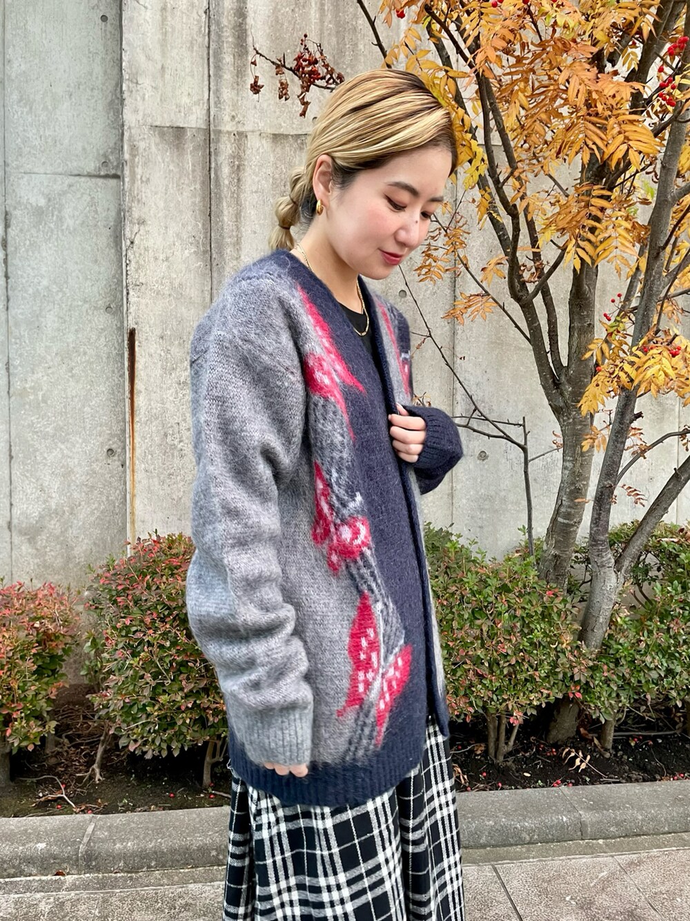 ホワイト系のスカート、ブラック系のブーツ、ブラック系のTシャツ/カットソーを着用したレディースの秋コーディネートの2枚目の写真