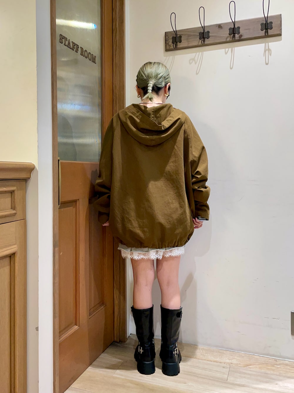 グリーン系のブルゾン、ブルー系のTシャツ/カットソー、グレー系のスカートを着用したレディースの秋コーディネートの2枚目の写真