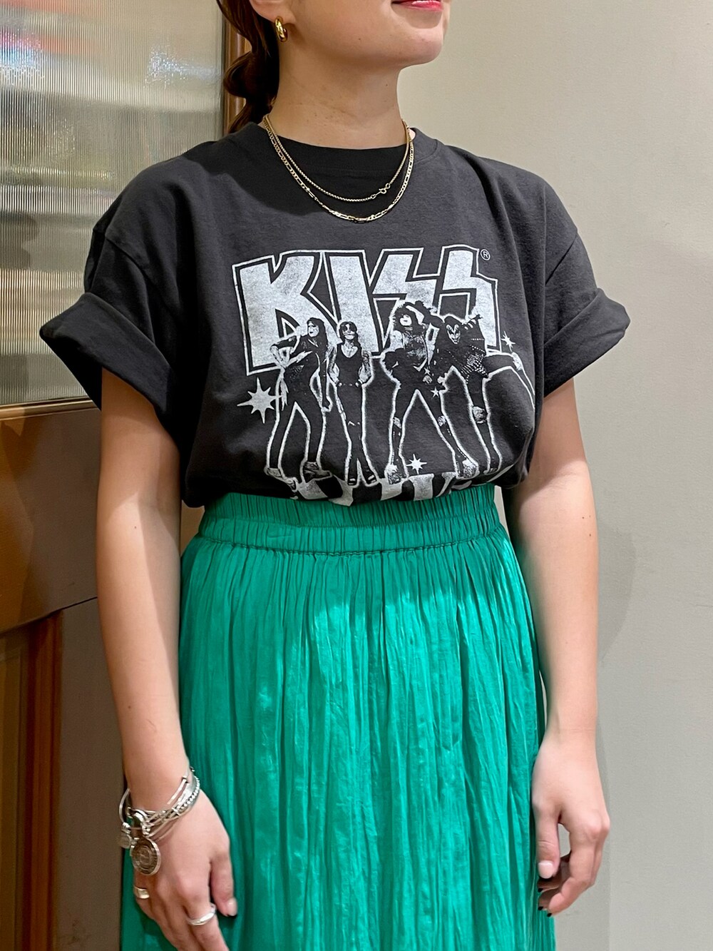 グリーン系のスカート、グレー系のTシャツ/カットソー、ブラック系のサンダルを着用したレディースの夏コーディネートの3枚目の写真