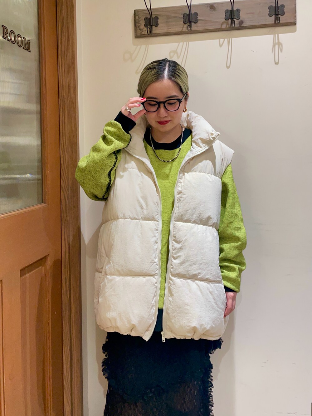 ブラック系のニット/セーター、ホワイト系のその他アウター、ブラック系のスカートを着用したレディースの秋コーディネートの2枚目の写真