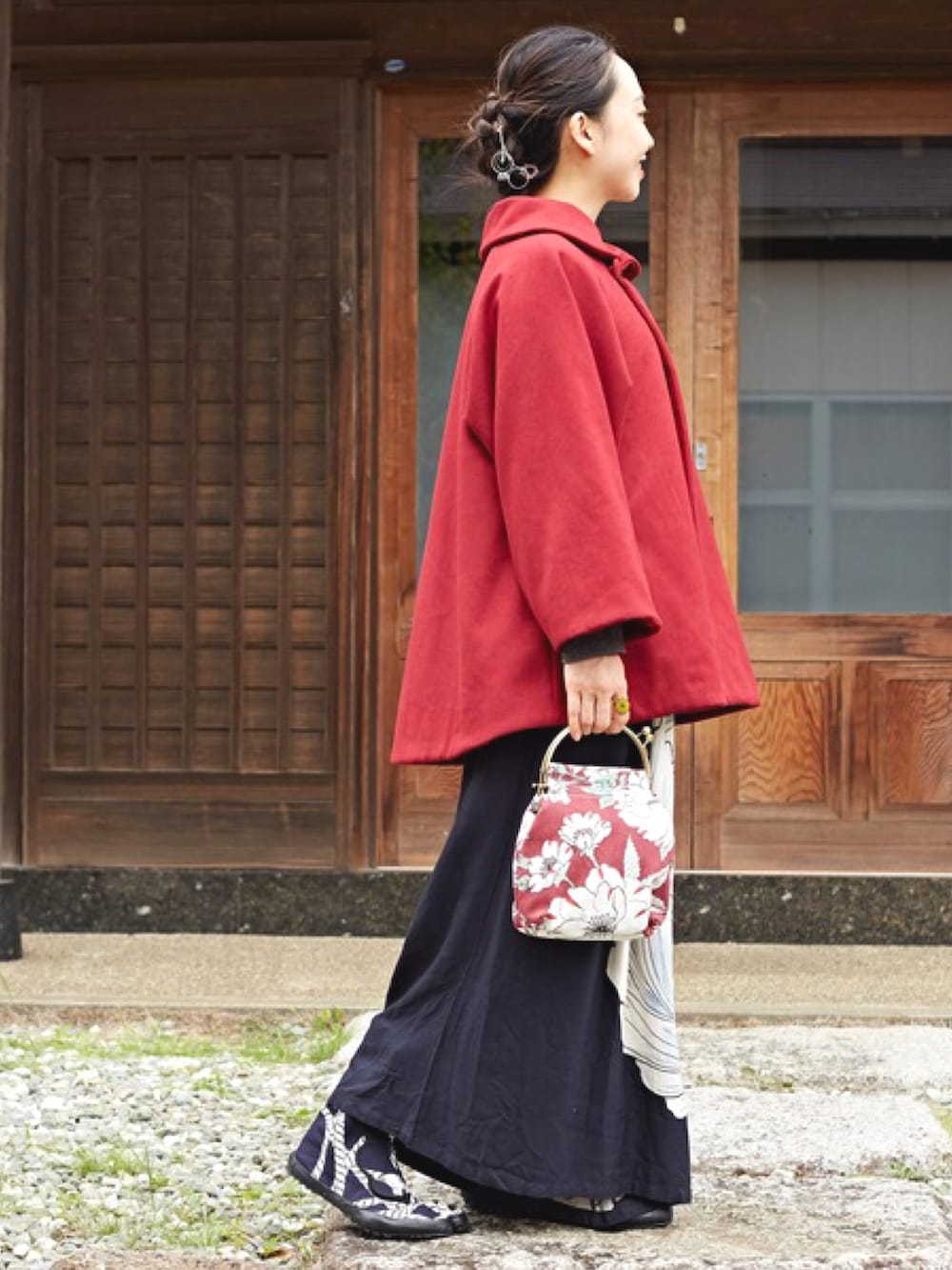 レッド系のその他アウター、レッド系のショルダーバッグ、ブラック系のワンピースを着用したレディースの秋コーディネートの2枚目の写真