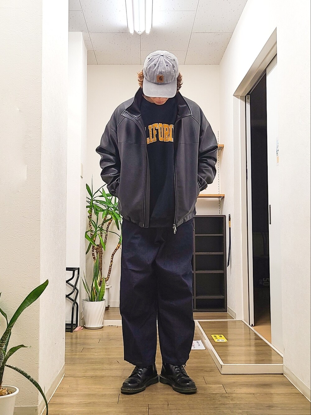 ブラック系のブーツ、ブルー系のデニムパンツ、ブルー系のスウェットを着用したメンズの春コーディネートの2枚目の写真