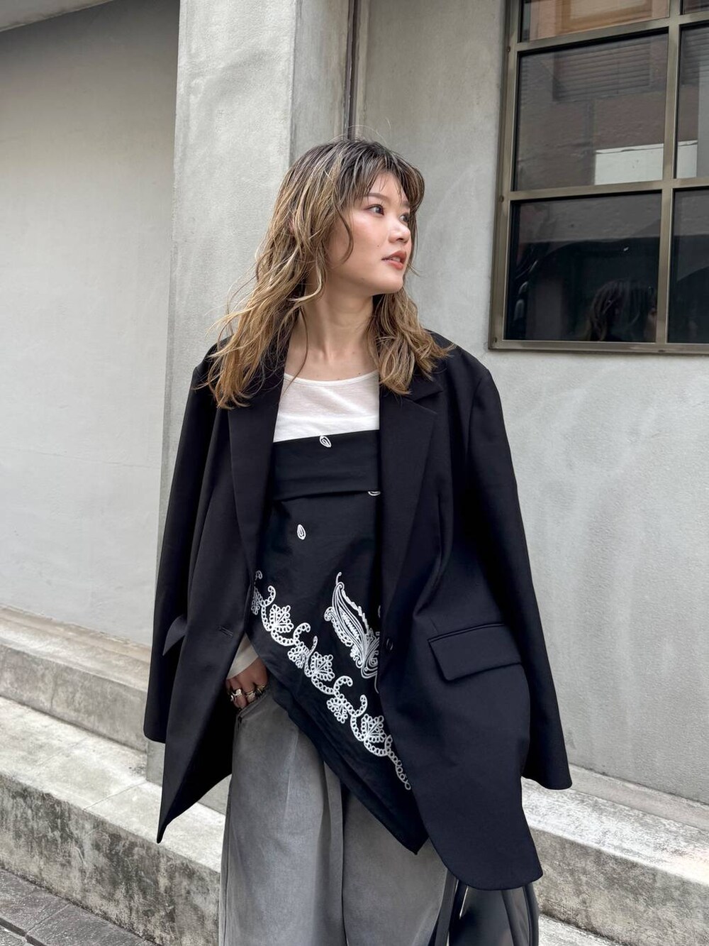 グレー系のデニムパンツ、ブラック系のテーラードジャケット、ホワイト系のTシャツ/カットソーを着用したレディースの春コーディネートの9枚目の写真