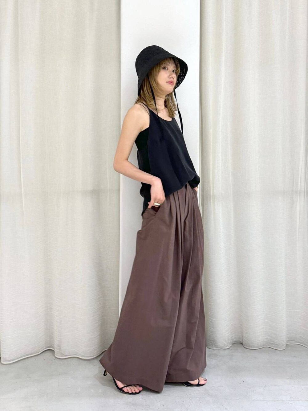 ブラック系のキャミソール、グレー系のその他パンツ、ブラック系のハットを着用したレディースの夏コーディネートの6枚目の写真