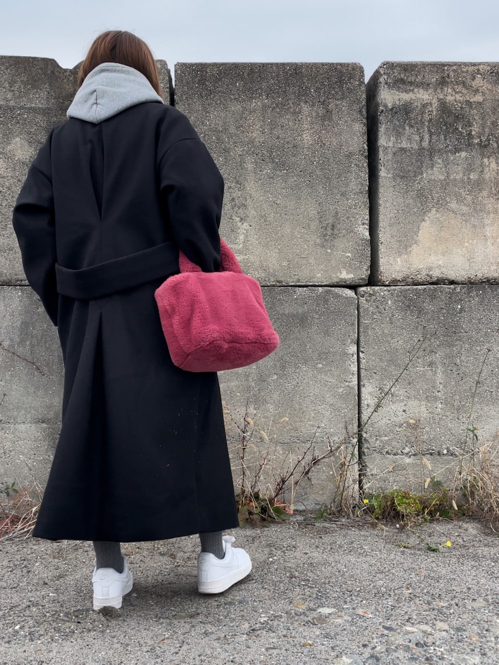 ブラック系のジャケット/アウター、ピンク系のハンドバッグ、グレー系のパーカーを着用したレディースの冬コーディネートの3枚目の写真