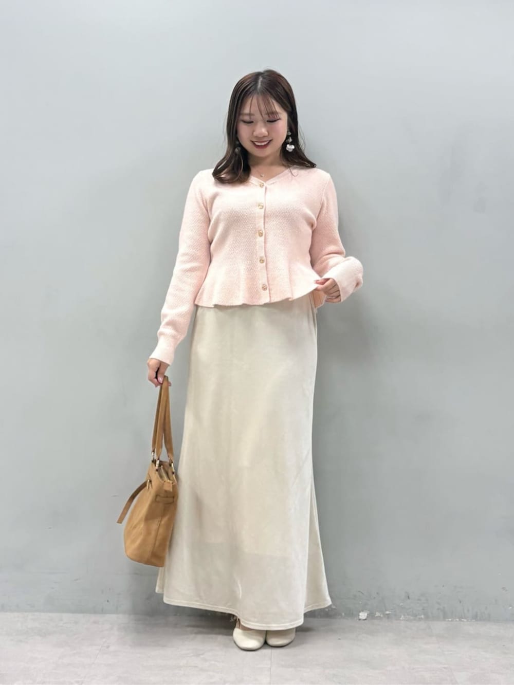 ホワイト系のスカート、ピンク系のニット/セーターを着用したレディースの冬コーディネートの2枚目の写真