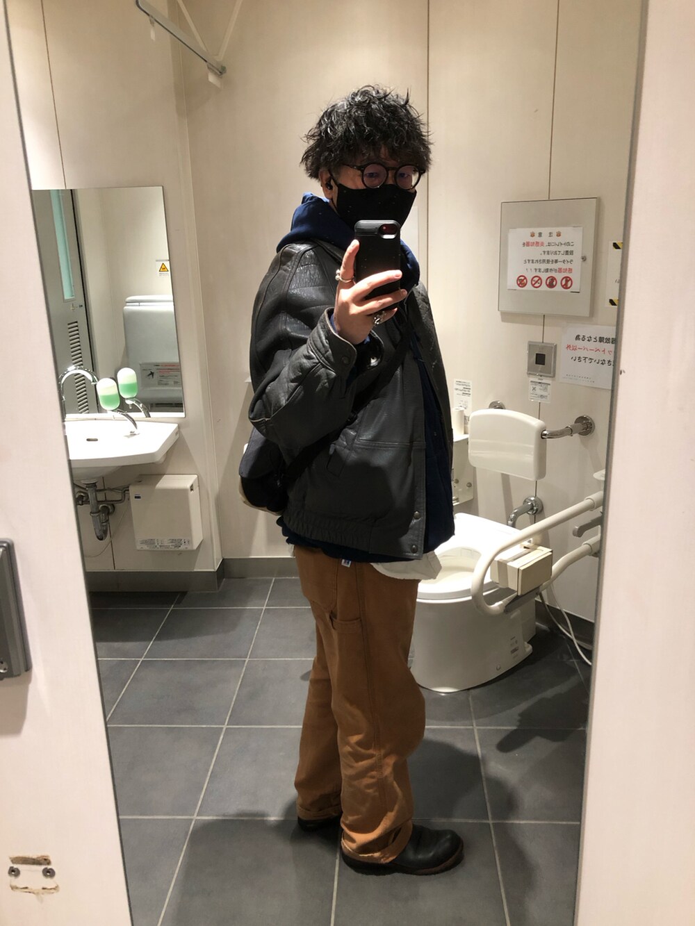 グレー系のブルゾン、ブラック系のブーツを着用したメンズの冬コーディネートの2枚目の写真