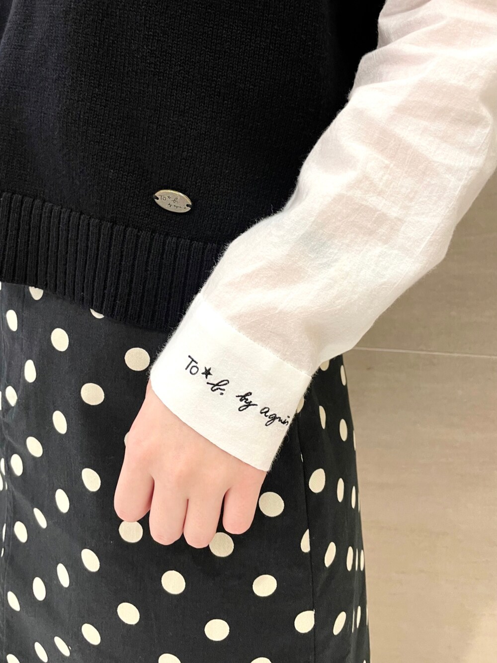 グリーン系のバックパック/リュック、ホワイト系のシャツ/ブラウス、ブラック系のベストを着用したレディースの夏コーディネートの3枚目の写真