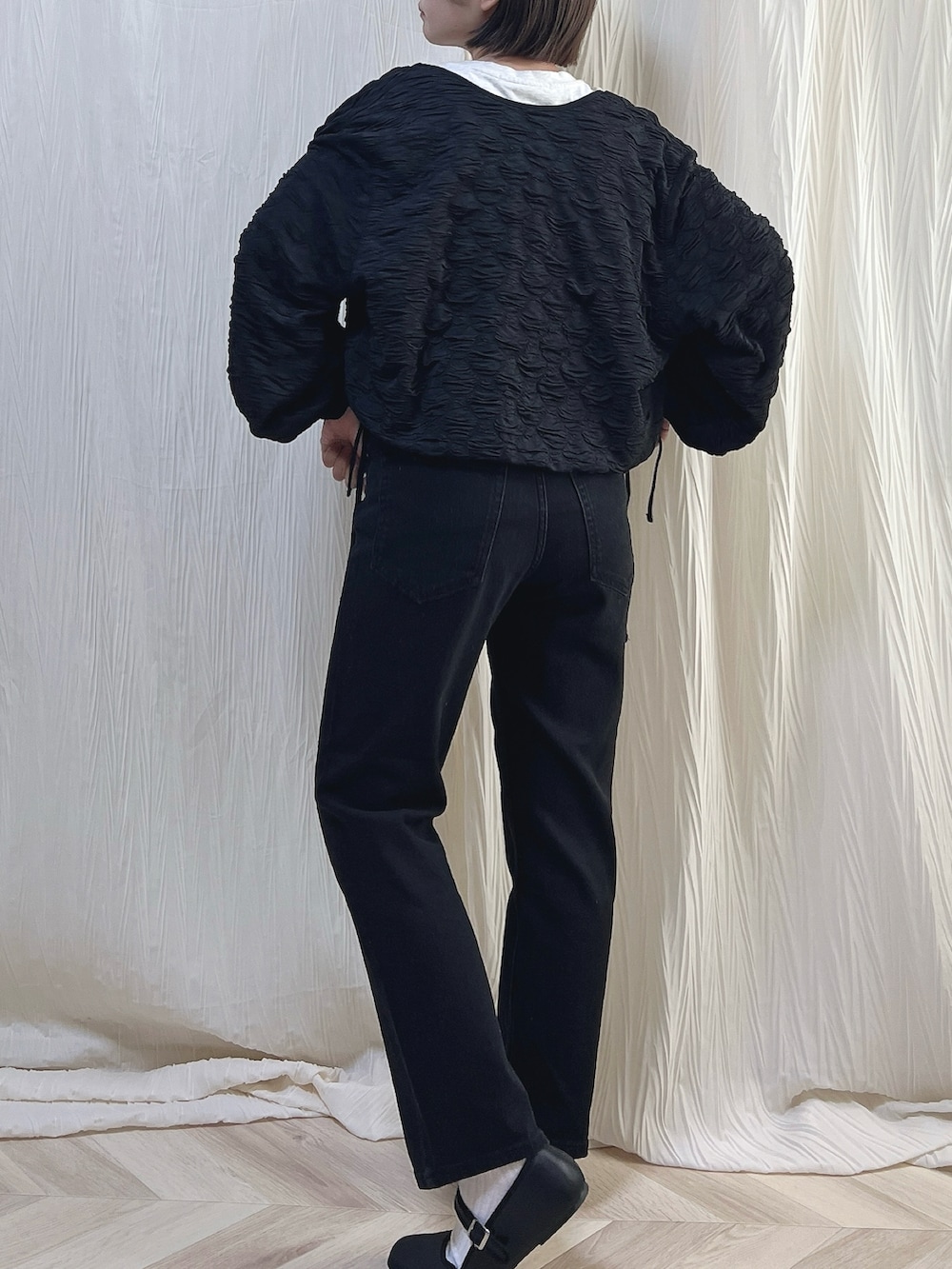 ベージュ系のTシャツ/カットソー、ブラック系のデニムパンツ、ブラック系のバレエシューズを着用したレディースの秋コーディネートの2枚目の写真