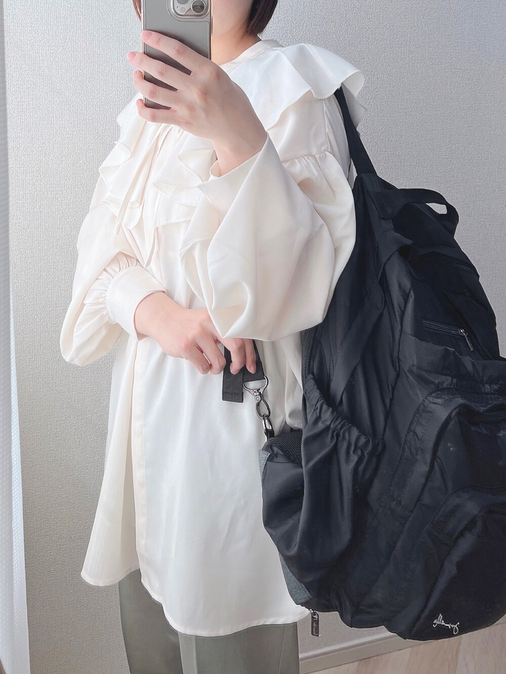 ベージュ系のシャツ/ブラウス、ブラック系のバックパック/リュック、ホワイト系のトップスを着用したレディースの夏コーディネートの3枚目の写真