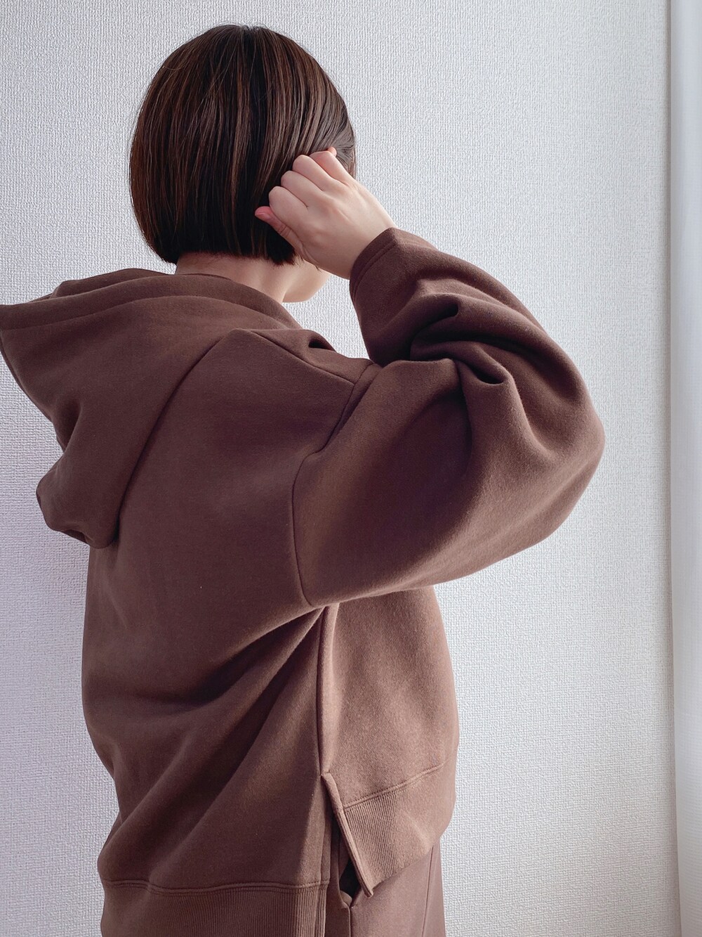 ブラウン系のパーカー、ブラウン系のスカート、ブラック系のローファーを着用したレディースの冬コーディネートの4枚目の写真