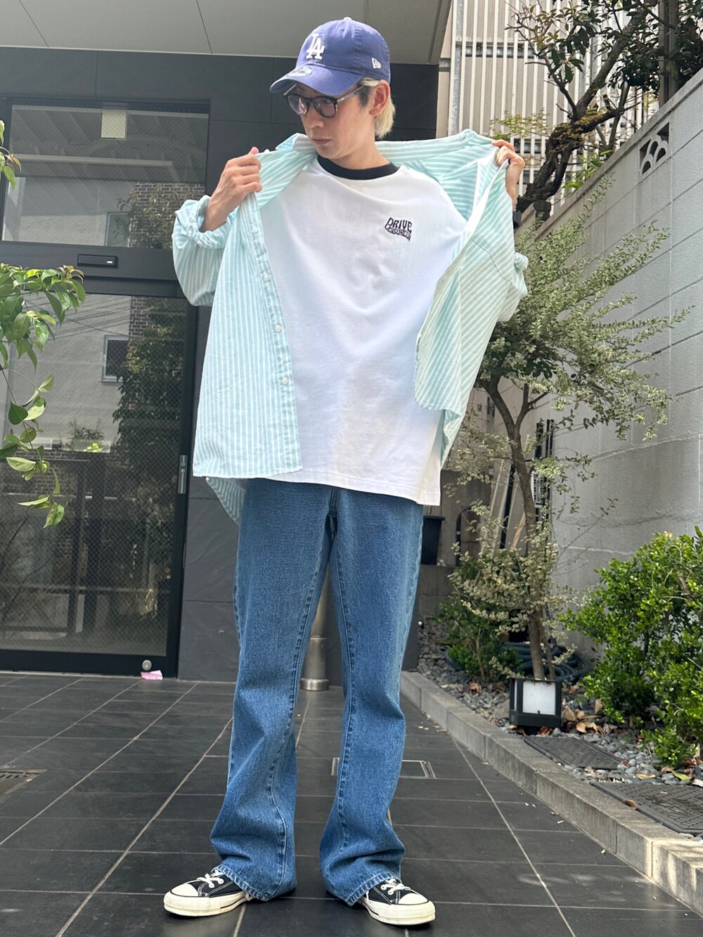 グリーン系のシャツ/ブラウス、その他のTシャツ/カットソー、ブルー系のデニムパンツを着用したメンズの春コーディネートの3枚目の写真