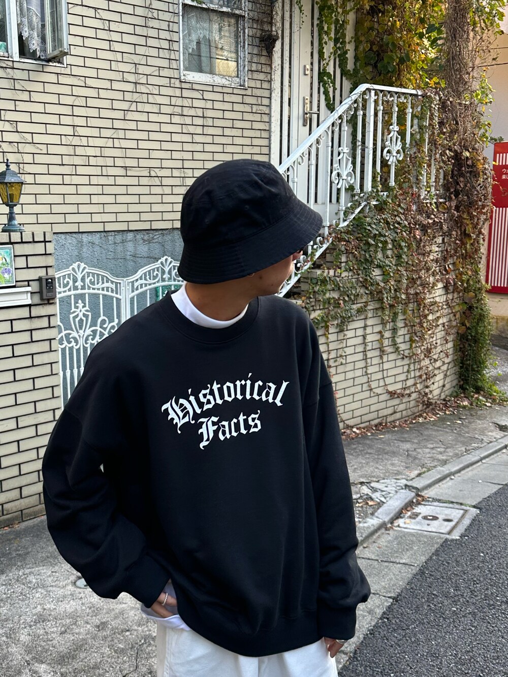 ブラック系のスウェット、ホワイト系のTシャツ/カットソー、ホワイト系のデニムパンツを着用したメンズの冬コーディネートの4枚目の写真
