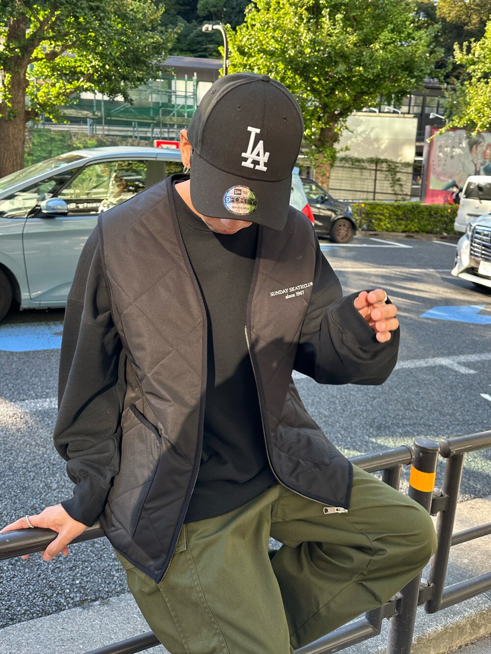 ブラック系のベスト、ブラック系のスウェット、グリーン系のカーゴパンツを着用したメンズの秋コーディネートの3枚目の写真