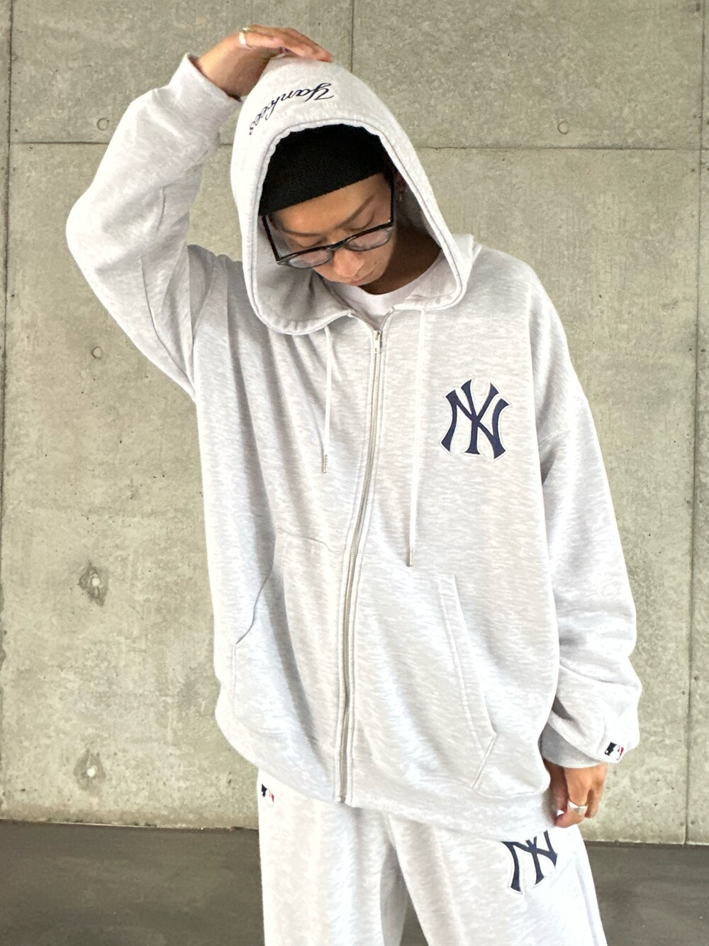 グレー系のパーカー、ホワイト系のTシャツ/カットソー、グレー系のスウェットパンツを着用したメンズの秋コーディネートの4枚目の写真