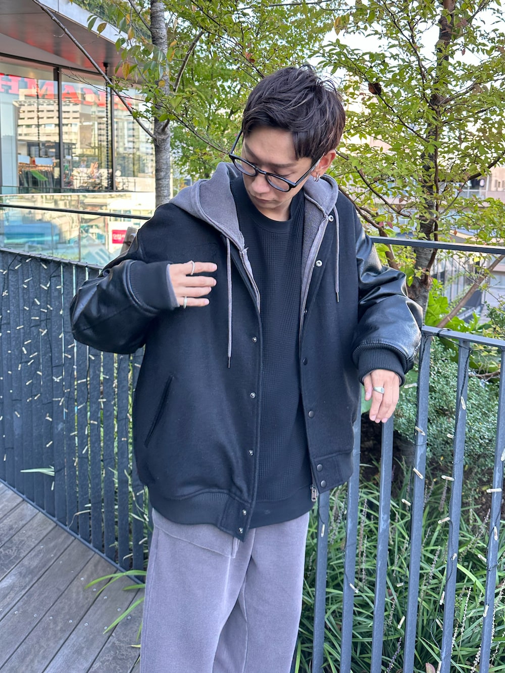 ブラック系のスタジャン、ブラウン系のパーカー、ブラック系のTシャツ/カットソーを着用したメンズの秋コーディネートの4枚目の写真