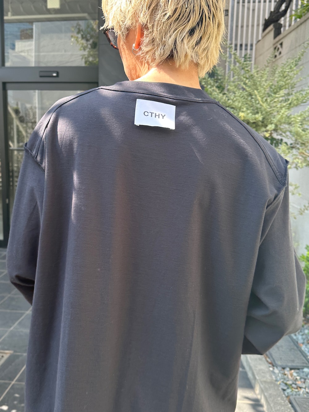 ブラック系のTシャツ/カットソー、ブルー系のデニムパンツ、ブラック系のショルダーバッグを着用したメンズの春コーディネートの5枚目の写真