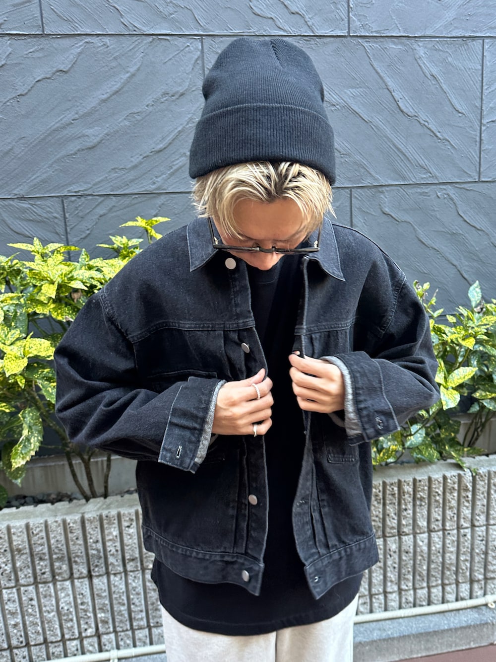 ブラック系のデニムジャケット、ブラック系のTシャツ/カットソー、ベージュ系のスウェットパンツを着用したメンズの冬コーディネートの4枚目の写真