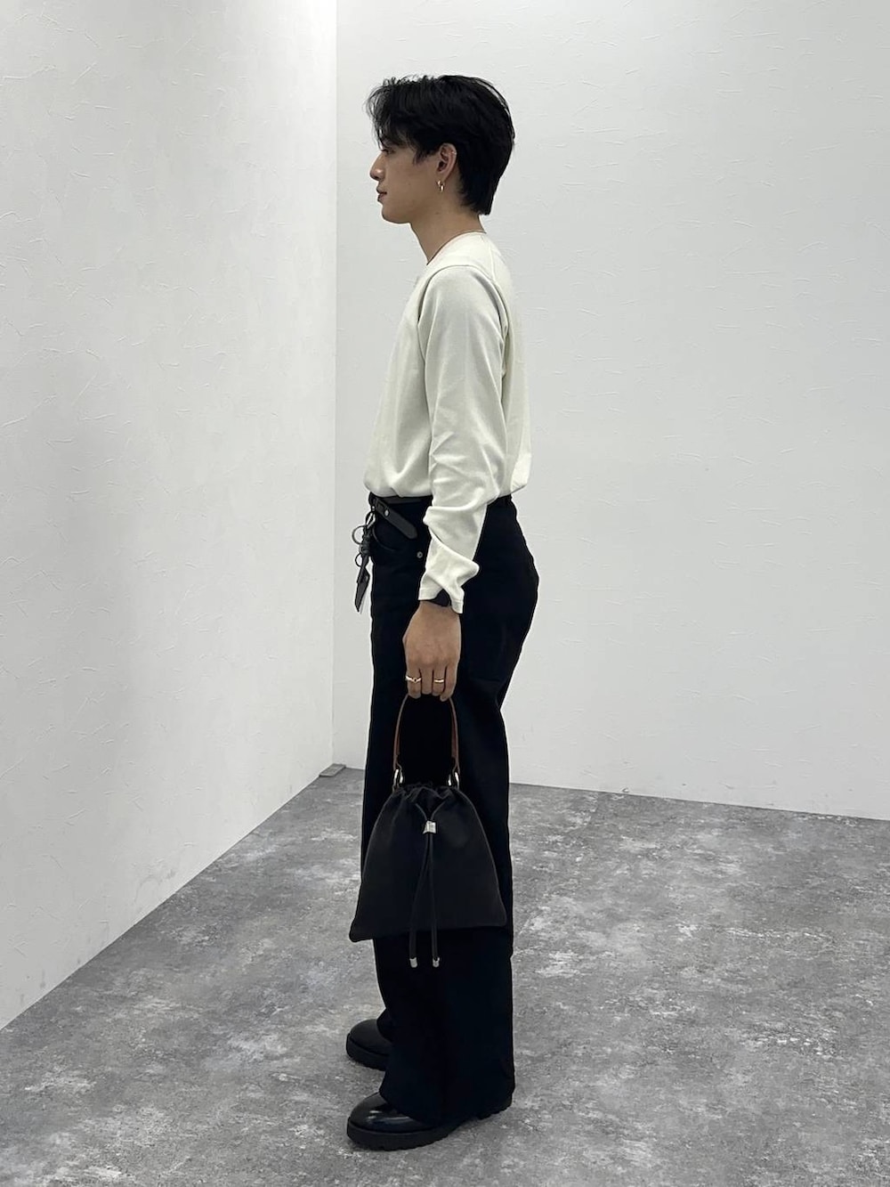 ブラック系のデニムパンツ、ブラック系のショルダーバッグを着用したメンズの春コーディネートの4枚目の写真