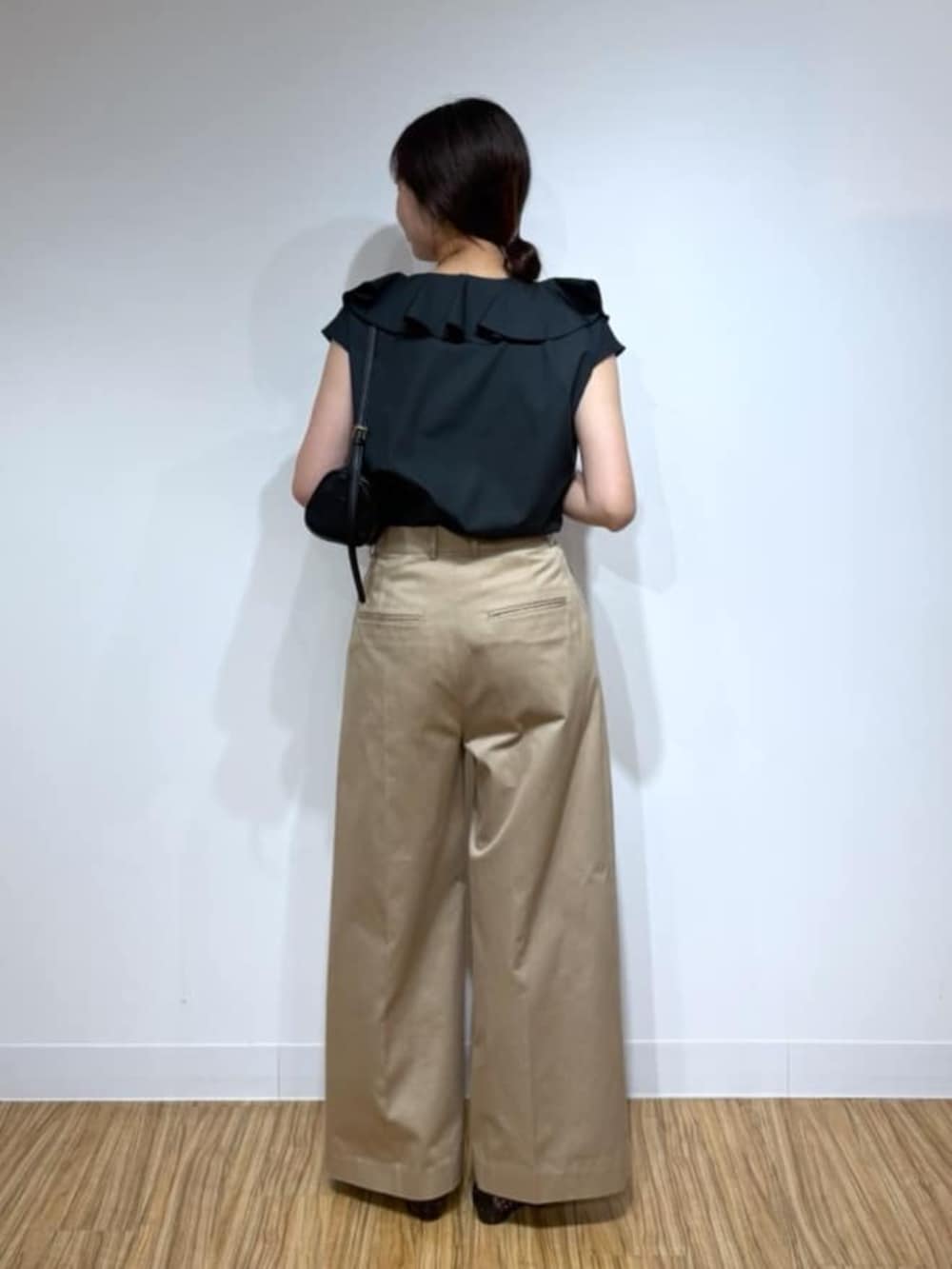 ベージュ系のその他パンツ、ブラック系のシャツ/ブラウス、ブラック系のショルダーバッグを着用したレディースの夏コーディネートの3枚目の写真