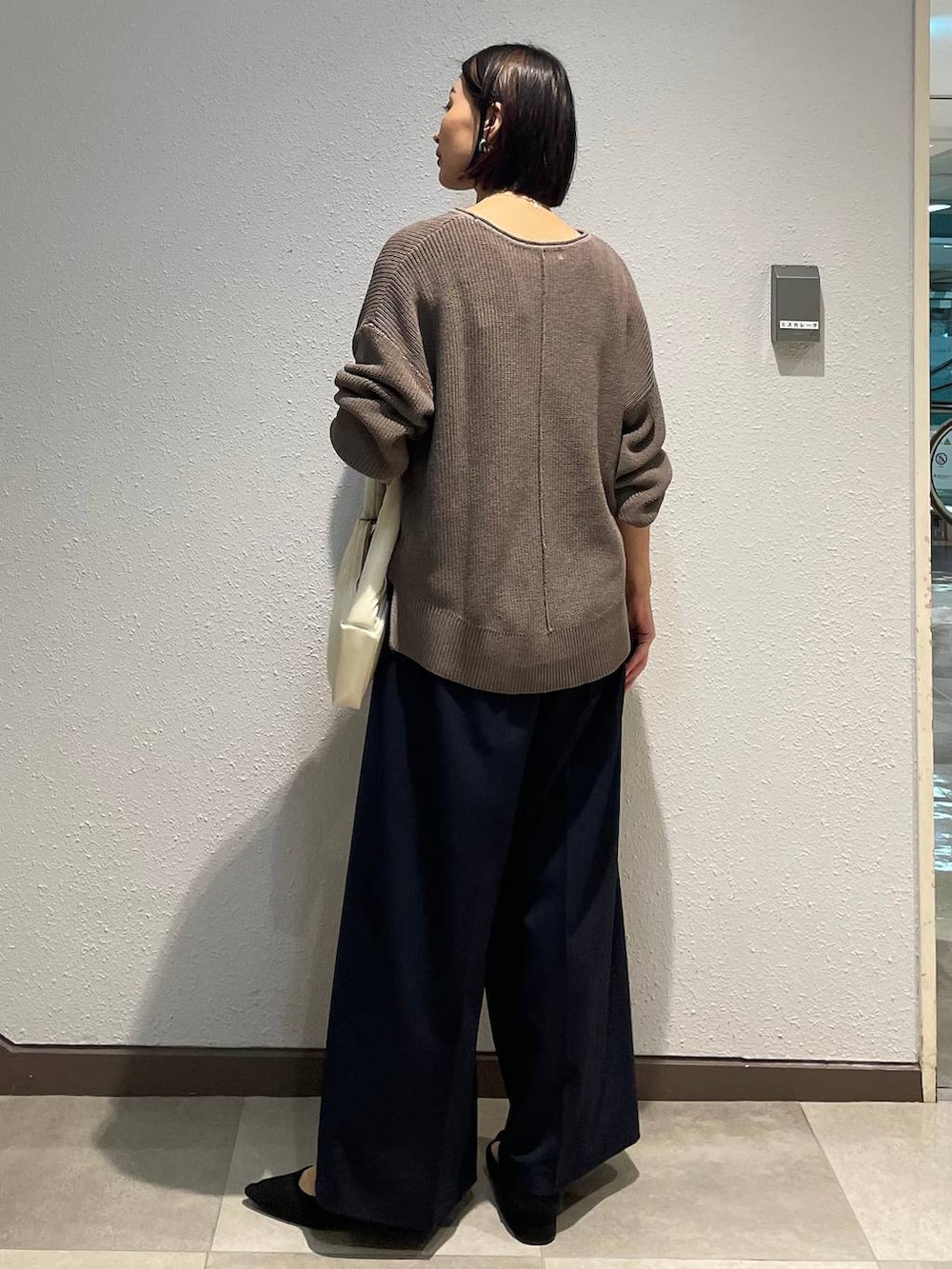 ブラック系のパンプス、ブルー系のその他パンツ、ブラウン系のニット/セーターを着用したレディースの春コーディネートの2枚目の写真