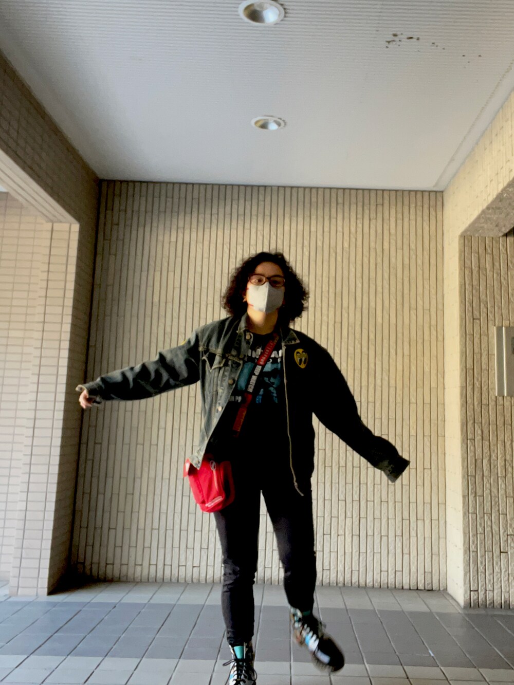 ブルー系のデニムジャケット、ブラック系のパンツ、その他のブーツを着用したレディースの冬コーディネートの2枚目の写真