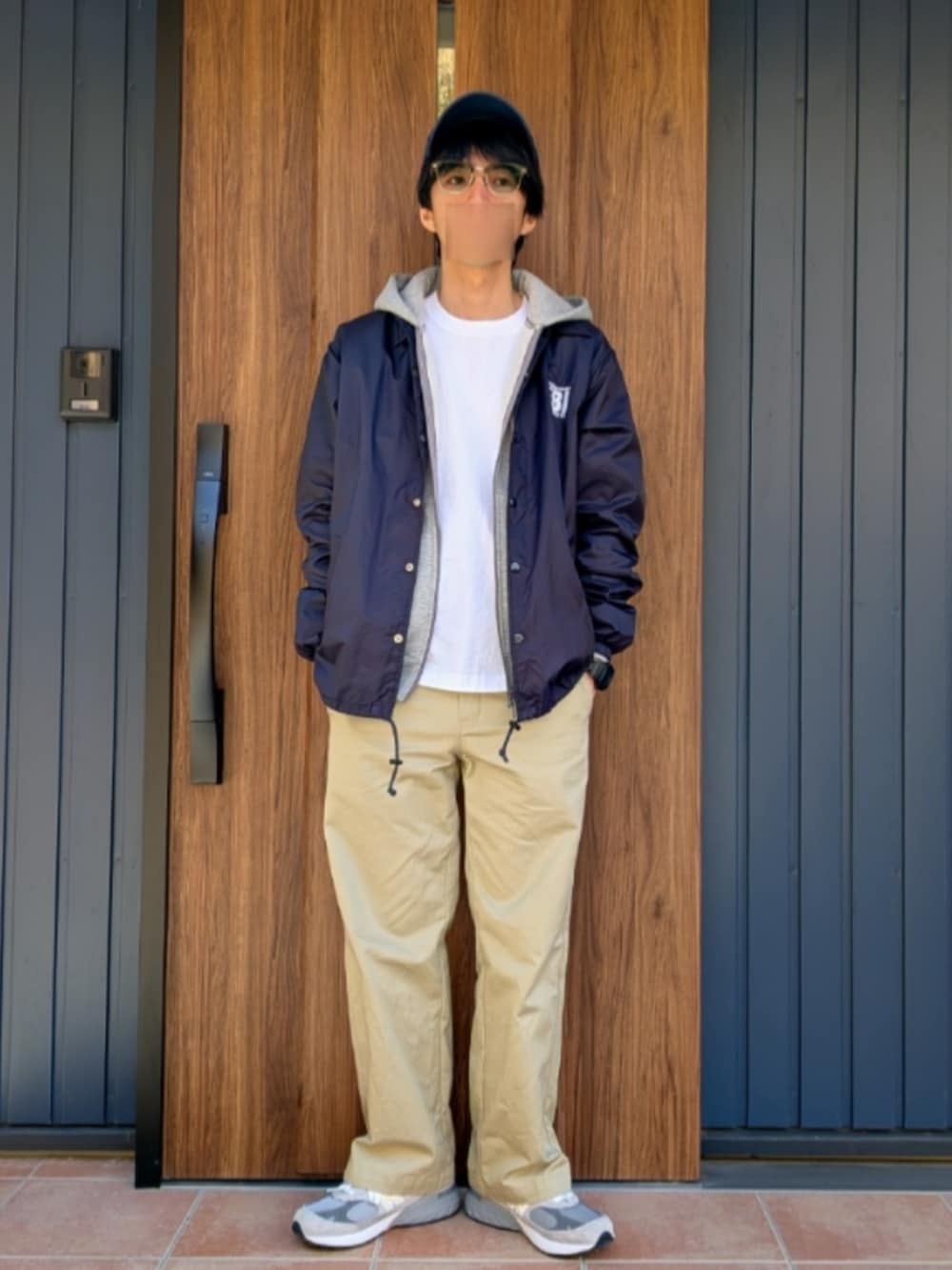 グレー系のスニーカー、ベージュ系のチノパンツ、ブルー系のナイロンジャケットを着用したメンズの冬コーディネートの5枚目の写真