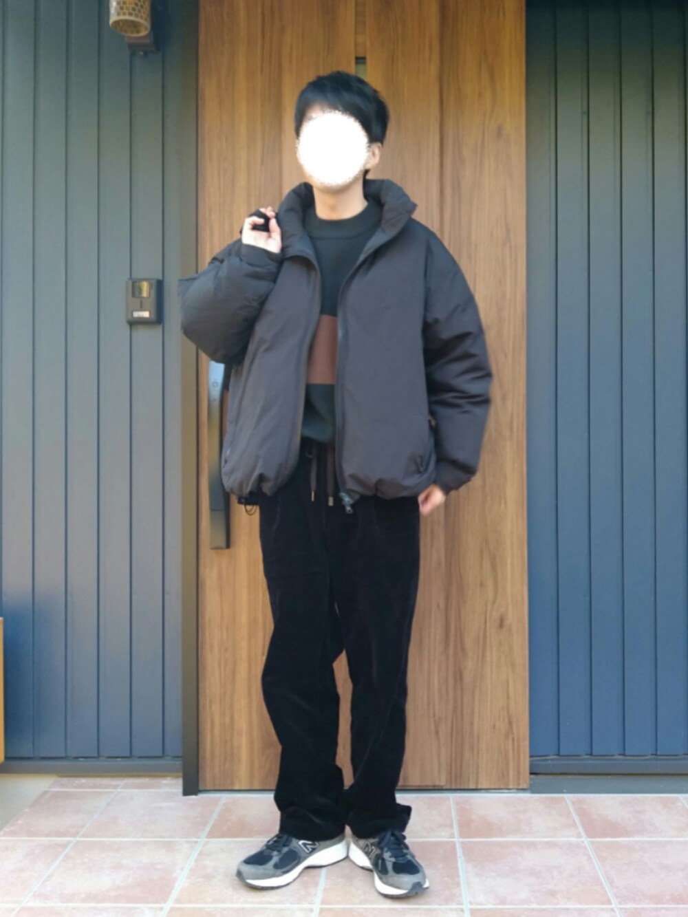 ブラック系のスニーカー、ブラック系のダウンジャケット/コート、ブラック系のニット/セーターを着用したメンズの冬コーディネートの5枚目の写真