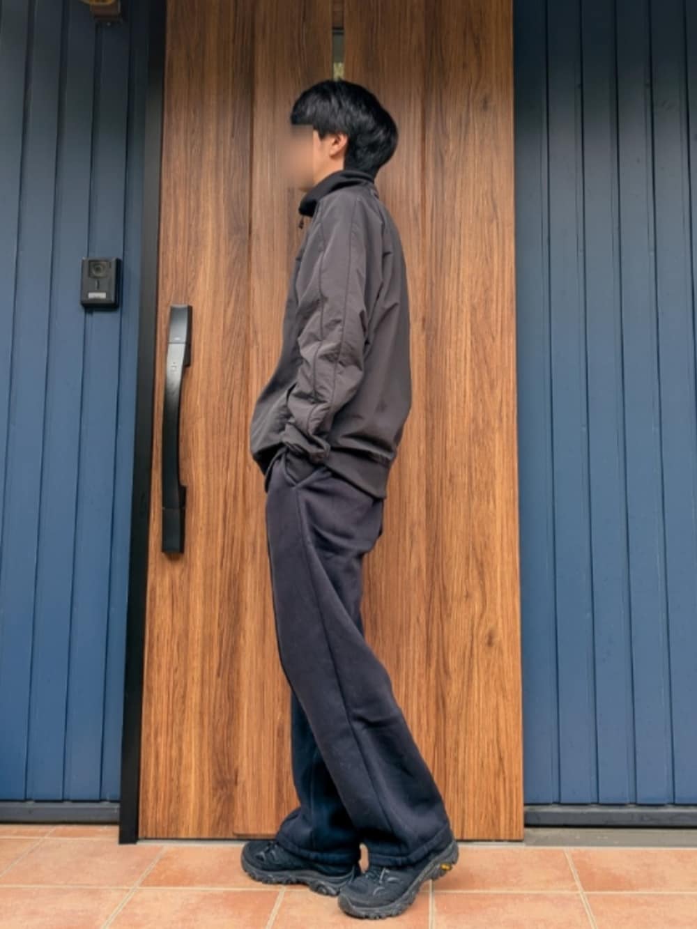 ブラック系のスニーカー、ブルー系のスウェットパンツ、ブラック系のブルゾンを着用したメンズの春コーディネートの2枚目の写真