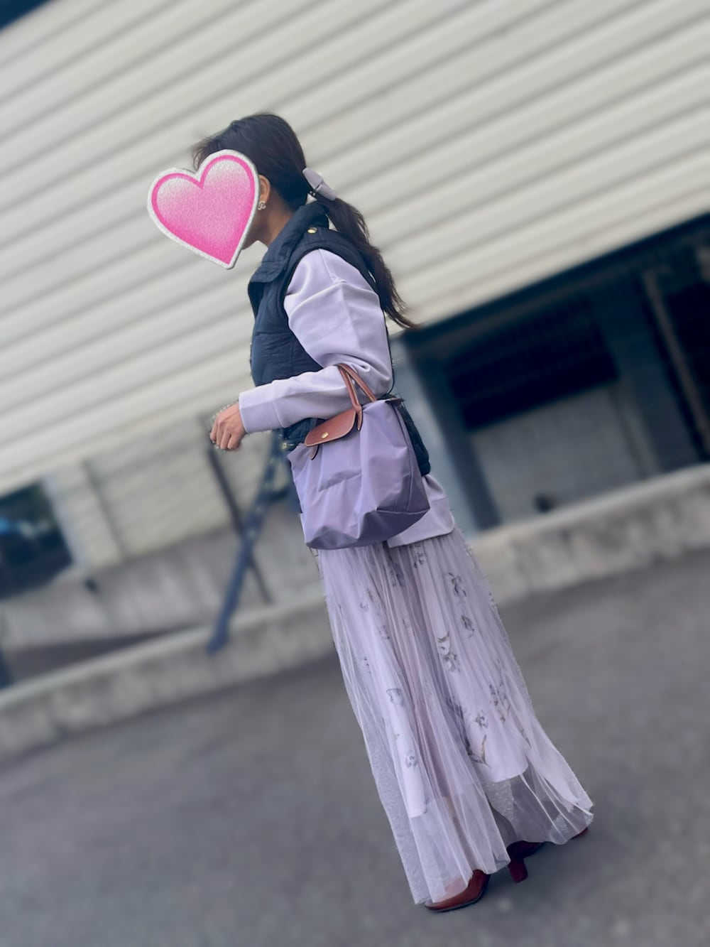 パープル系のスカート、パープル系のTシャツ/カットソー、パープル系のハンドバッグを着用したレディースの冬コーディネートの2枚目の写真