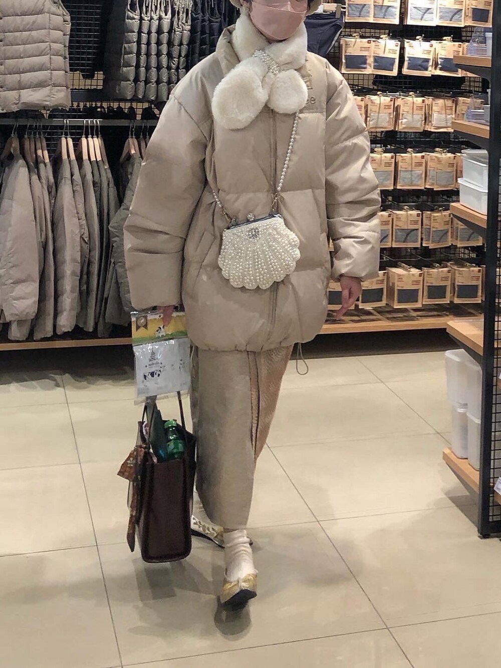 ベージュ系のダウンジャケット/コートを着用したレディースの冬コーディネートの2枚目の写真