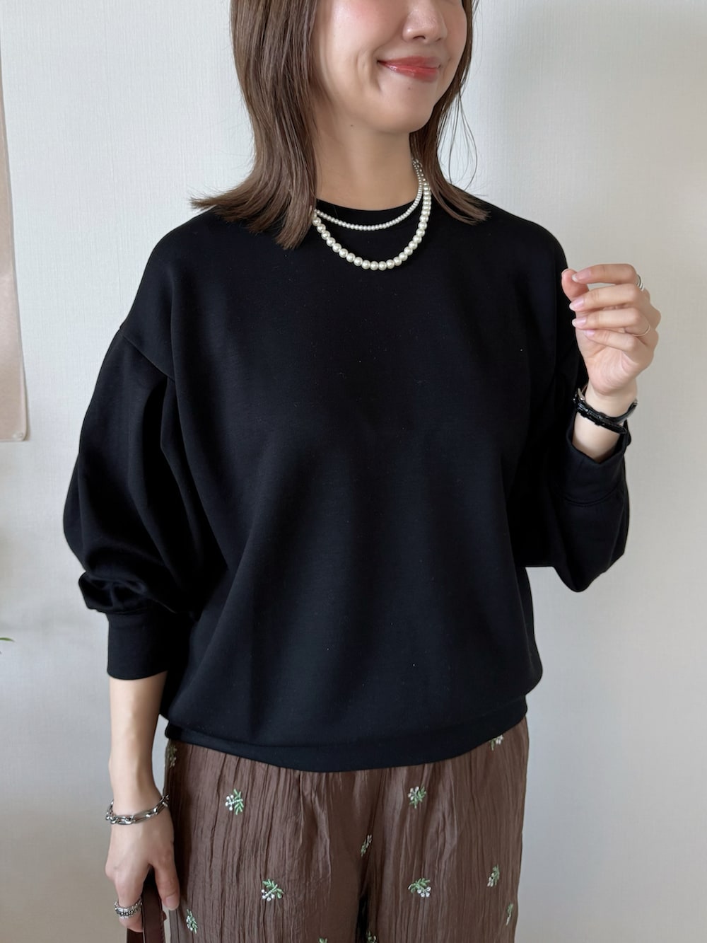 ブラック系のTシャツ/カットソー、ブラウン系のその他パンツ、ブラウン系のハンドバッグを着用したレディースの春コーディネートの4枚目の写真