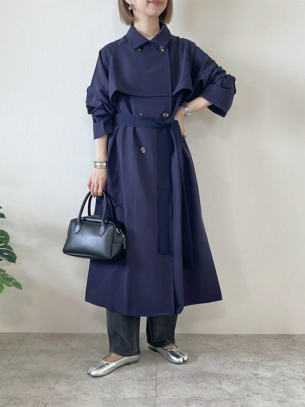 ホワイト系のTシャツ/カットソー、ブラック系のデニムパンツ、ブルー系のトレンチコートを着用したレディースの春コーディネートの2枚目の写真