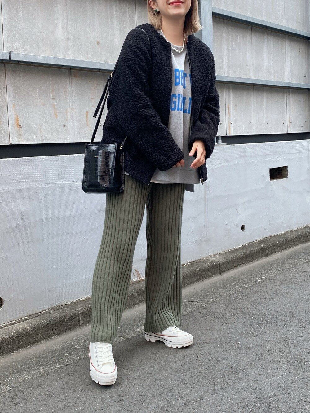 ブラック系のジャケット/アウター、グレー系のベスト、ブラック系のバッグを着用したレディースの冬コーディネートの2枚目の写真