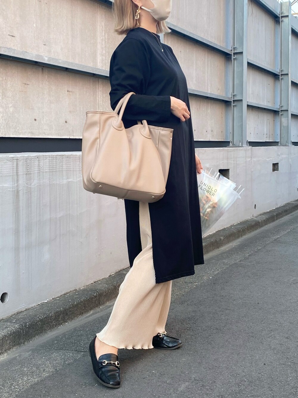 ベージュ系のバッグ、ゴールド系のピアス（両耳用）を着用したレディースの春コーディネートの2枚目の写真