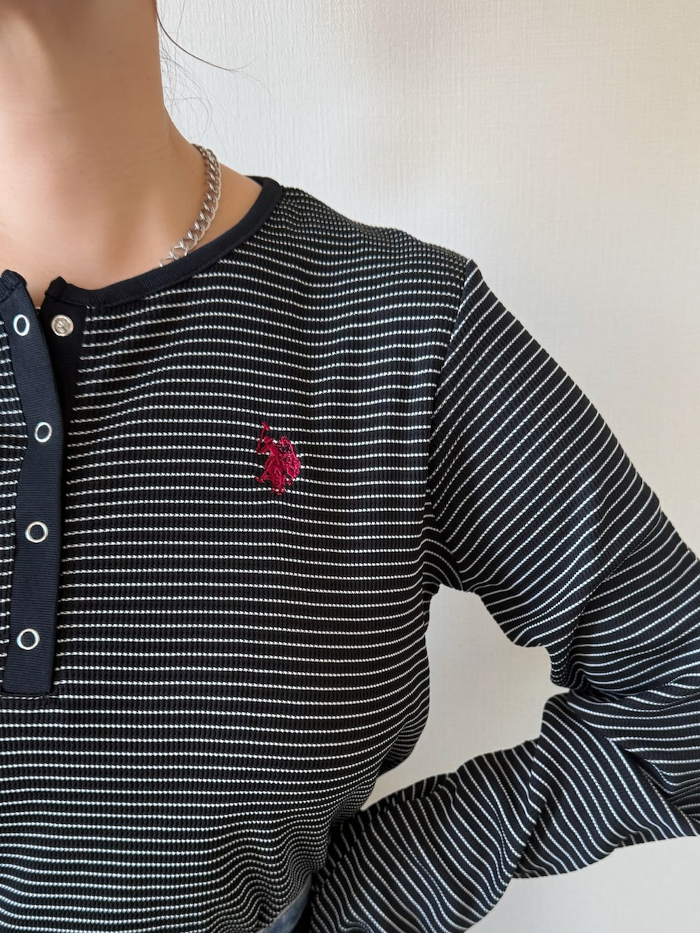 ブラック系のTシャツ/カットソー、ブラック系のショルダーバッグ、ブラック系のスニーカーを着用したレディースの冬コーディネートの5枚目の写真