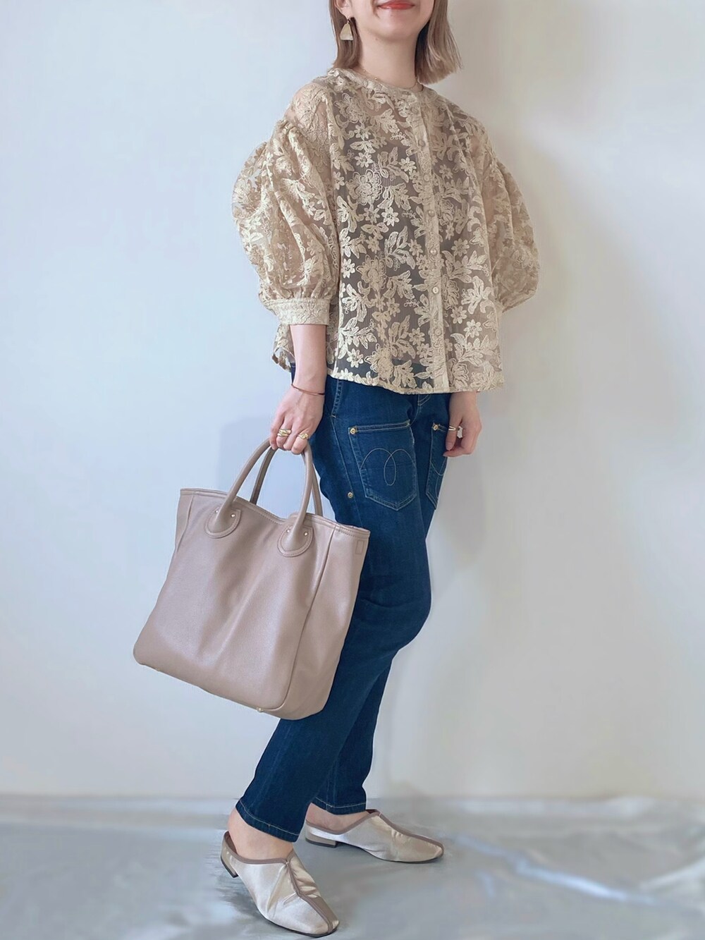 ベージュ系のバッグ、ベージュ系のサンダル、ベージュ系のシャツ/ブラウスを着用したレディースの春コーディネートの2枚目の写真