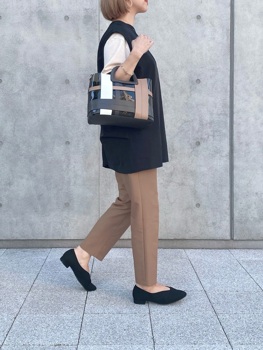 ブラック系のパンプス、ブラック系のバッグ、ブラウン系のその他パンツを着用したレディースの秋コーディネートの3枚目の写真