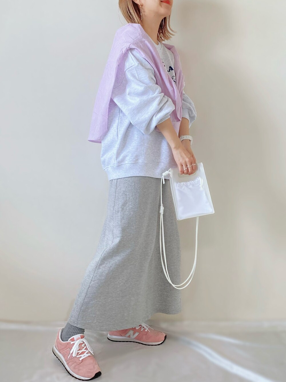 ピンク系のシャツ/ブラウス、ホワイト系のトップス、グレー系のスカートを着用したレディースの春コーディネートの2枚目の写真