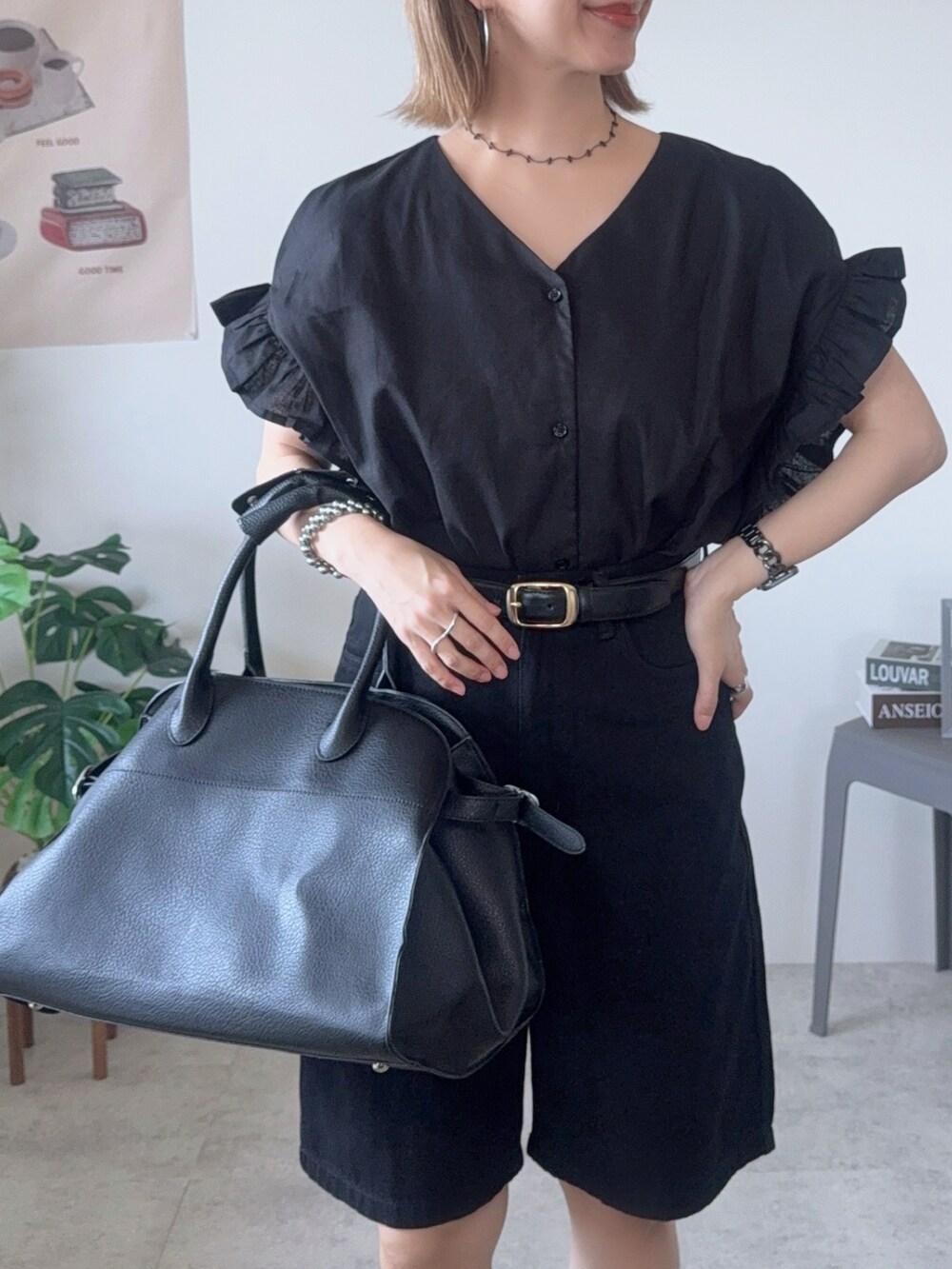 ブラック系のシャツ/ブラウス、ブラック系のボストンバッグ、ホワイト系のサンダルを着用したレディースの夏コーディネートの4枚目の写真