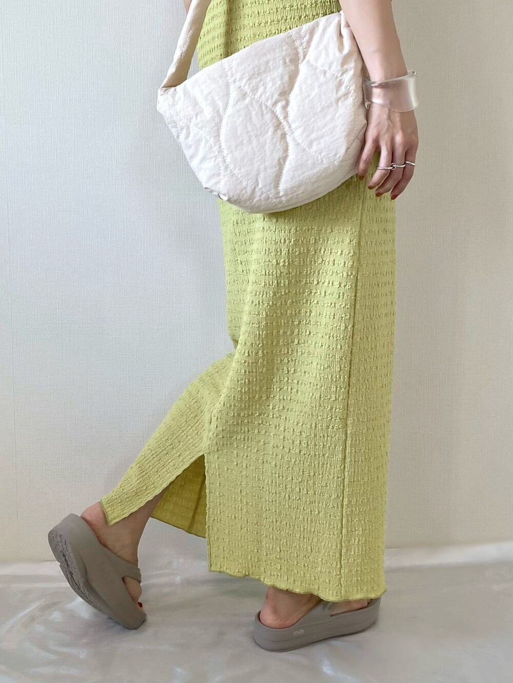 グリーン系のスカート、グリーン系のTシャツ/カットソー、ベージュ系のサンダルを着用したレディースの春コーディネートの4枚目の写真